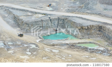 Aerial Open-Pit Mining with Dump Truck and Turquoise Pools 118017380