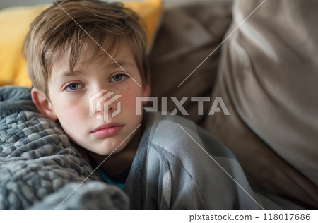 Boy resting on couch 118017686