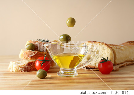 The concept of Italian cuisine, olive oil, on a light background. The concept of Italian cuisine, olive oil, on a light background. 118018143