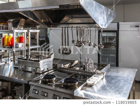 Empty Professional Kitchen in a Modern Restaurant. Concept of clean and ready-to-use cooking space Empty Professional Kitchen in a Modern Restaurant. Concept of clean and ready-to-use cooking space 118019805