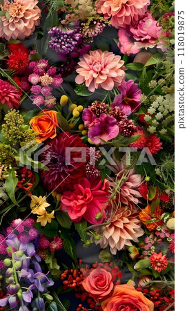 Vibrant Display of Dahlias, Roses, and Small Purple Flowers Amidst Lush Green Foliage 118019875