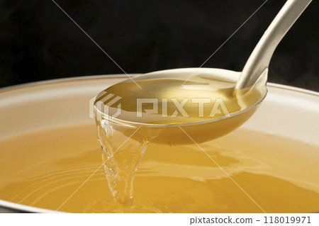 Dashi soup: Scoop out the dashi soup with a ladle Dashi soup: Scoop out the dashi soup with a ladle 118019971