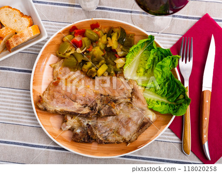 Roasted pork chop served with stewed vegetables 118020258