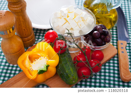 Cooking Greek salad with mozzarella cheese. Ingredients on the table 118020318