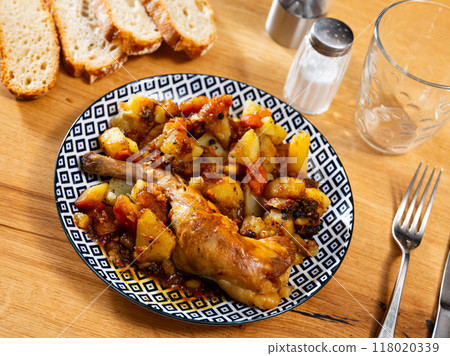 Fried rabbit served with potatoes on platter 118020339