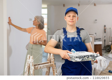Teenage boy posing on indoor construction site Teenage boy posing on indoor construction site 118020655