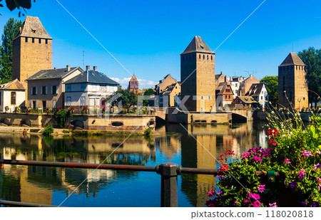 Strasbourg, France. Barrage Vauban scenic river and architecture view on bridge Ponts Couverts with flowers Strasbourg, France. Barrage Vauban scenic river and architecture view on bridge Ponts Couverts with flowers 118020818