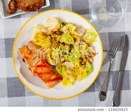 Grilled salmon steak with fresh lettuce salad 118020825