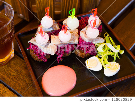 Canapes of pickled herring with beets 118020839