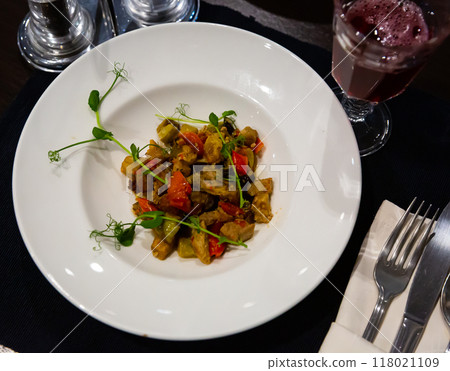 Stewed vegetables on a plate, decorated with herbs 118021109