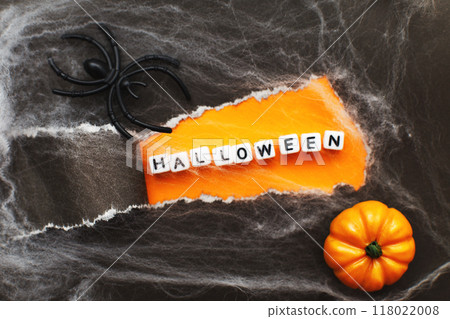 curl of torn black paper on orange background. halloween sale concept curl of torn black paper on orange background. halloween sale concept 118022008