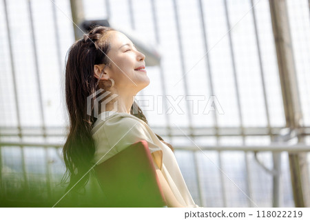 Woman relaxing at the airport Woman relaxing at the airport 118022219