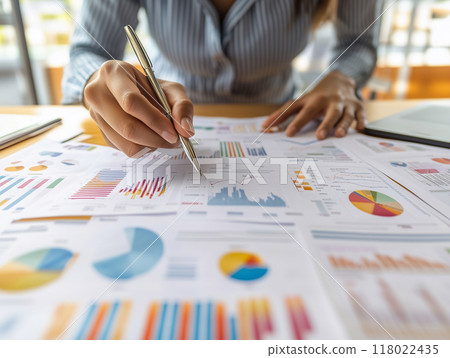 Entrepreneur reviewing a detailed business plan with graphs and charts, business strategy visualizat 118022435