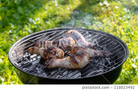 chicken legs on a grill chicken legs on a grill 118023492