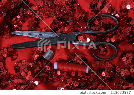 Red Beaded Fabric With Spool of Thread and Thimble 118023587