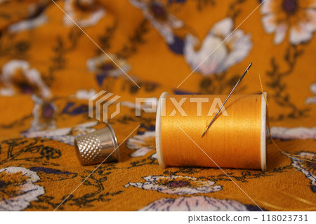 Golden Yellow Thread on Vintage Fabric Close-up Golden Yellow Thread on Vintage Fabric Close-up 118023731
