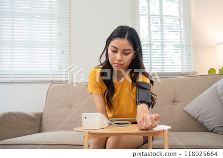 Using a digital device to check blood pressure at home Using a digital device to check blood pressure at home 118025664