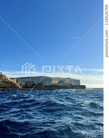 Beautiful view of the cliffs of the island of Gozo, Malta. Blue water of the Mediterranean Sea. Beautiful view of the cliffs of the island of Gozo, Malta. Blue water of the Mediterranean Sea. 118026766