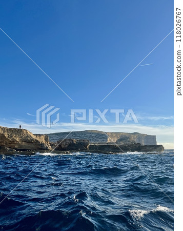 Beautiful view of the cliffs of the island of Gozo, Malta. Blue water of the Mediterranean Sea. 118026767