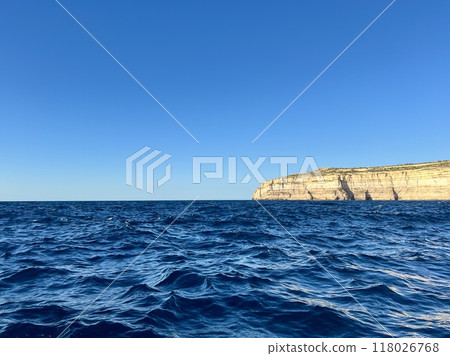 Beautiful view of the cliffs of the island of Gozo, Malta. Blue water of the Mediterranean Sea. Beautiful view of the cliffs of the island of Gozo, Malta. Blue water of the Mediterranean Sea. 118026768