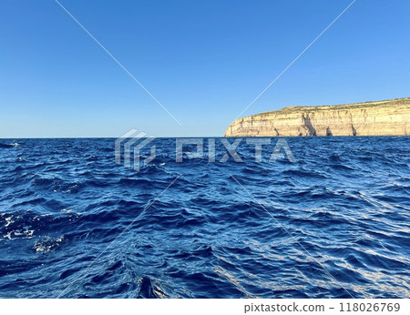 Beautiful view of the cliffs of the island of Gozo, Malta. Blue water of the Mediterranean Sea. 118026769