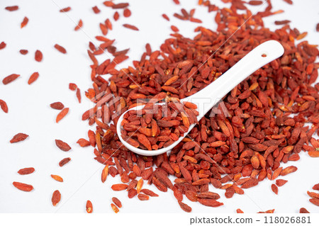 Dried Goji berries Lycium barbarum in a spoon on a white background Dried Goji berries Lycium barbarum in a spoon on a white background 118026881