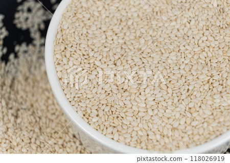 White roasted sesame seeds in a plate. 118026919
