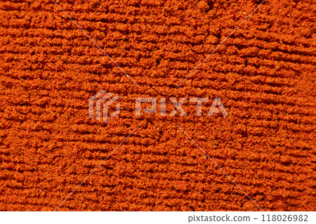 Abstract terracotta striped background of scattered paprika seasoning Abstract terracotta striped background of scattered paprika seasoning 118026982
