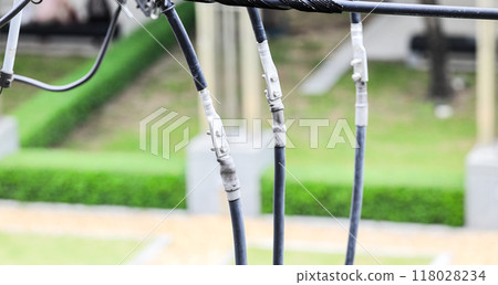 Closeup Connection Point of Electricity line and electricity post wtih blue sky background. 118028234