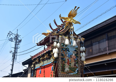 Old streetscape of Takayama City, Gifu Prefecture, Takayama Festival in spring, gorgeous floats called yatai, large hanging scrolls, beautiful decorations and blue sky 118028266
