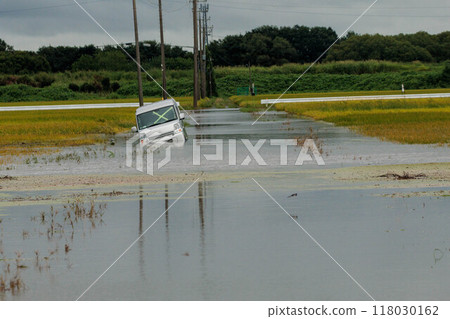 A car submerged in floodwaters caused by heavy rain 118030162