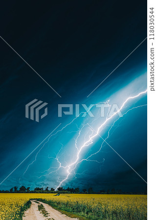 Dramatic Rain Sky With Rain Clouds On Horizon Above Rural Landscape Camola Colza Rapeseed Field. Country Road. Agricultural And Weather Forecast Concept 118030544
