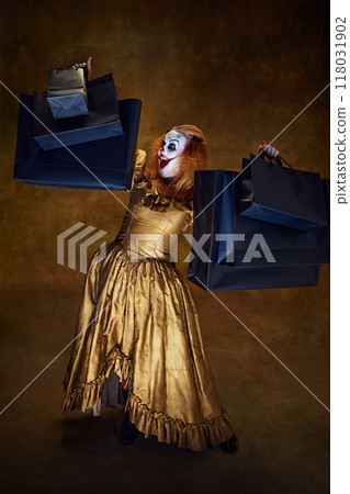 Woman with scary make-up in golden dress, dramatically lifting shopping bags, her expression of shock against vintage background. 118031902