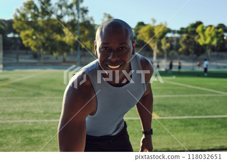 Atheltic man posing for camera, soccer field on background Atheltic man posing for camera, soccer field on background 118032651