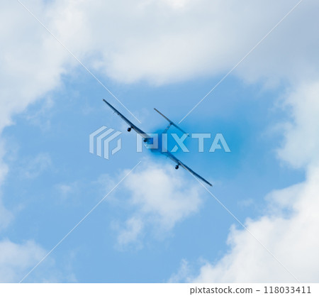 plane with colorful trail in the sky 118033411