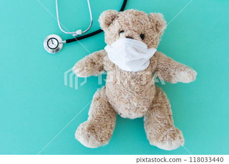 Teddy bear in mask near phonendoscope 118033440