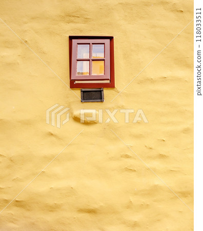Small brown window on the yellow masonry wall Small brown window on the yellow masonry wall 118033511