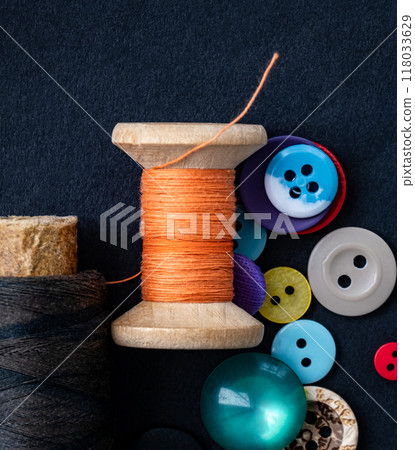 Sewing buttons and thread spool 118033629
