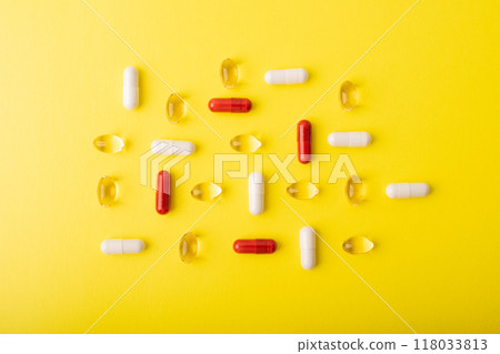 Pills. Supplements patern. White pills, red capsules isolated on yellow background. An allergy pill, antibiotics. Medicine, healthcare concept. Virus(viral) and flu diseases. High quality photo 118033813