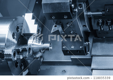 Close up scene the CNC lathe machine cutting the metal cone shape parts in the light blue scene. Close up scene the CNC lathe machine cutting the metal cone shape parts in the light blue scene. 118035339