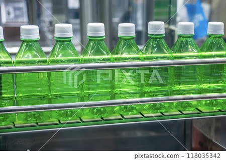 The  empty drinking water bottles  on the conveyor belt for filling process. 118035342