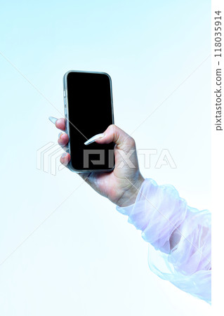 Hand of spooky white ghost holding smartphone with blank screen against gradient background. Negative space for your ad. Hand of spooky white ghost holding smartphone with blank screen against gradient background. Negative space for your ad. 118035914