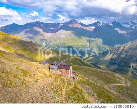 The Breslauer Hut rests atop a rugged landscape in the Otztal Alps, providing stunning views of surrounding peaks and valleys. Cloud formations add depth to the alpine scenery, inviting exploration. The Breslauer Hut rests atop a rugged landscape in the Otztal Alps, providing stunning views of surrounding peaks and valleys. Cloud formations add depth to the alpine scenery, inviting exploration. 118036010
