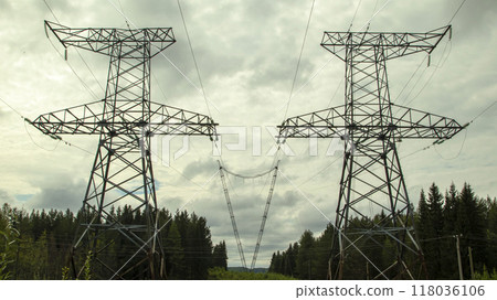 high voltage power lines against a gloomy sky 118036106