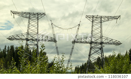 high voltage power lines against a gloomy sky 118036107