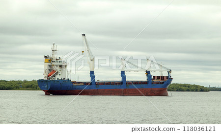 A large cargo sea vessel is at anchor, a dry cargo ship is at anchor A large cargo sea vessel is at anchor, a dry cargo ship is at anchor 118036121