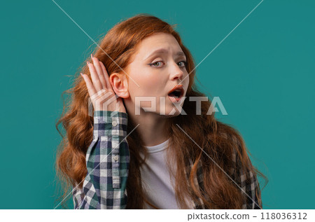 Curious ginger woman doesn't hear, asking what. Quiet sound, deaf, misunderstand Curious ginger woman doesn't hear, asking what. Quiet sound, deaf, misunderstand 118036312
