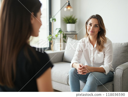 Therapist in a one-on-one counseling session with a client 118036590