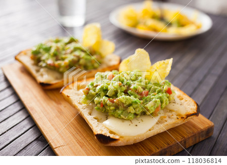 Morning toast with melted cheese and guacamol Morning toast with melted cheese and guacamol 118036814