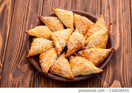 Homemade triangle puff pastry with meat on rustic background . Samosa Homemade triangle puff pastry with meat on rustic background . Samosa 118036850
